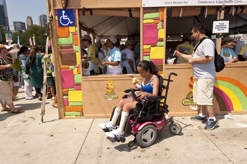Person in wheelchair at Taste of Chicago vendor's accessible counter